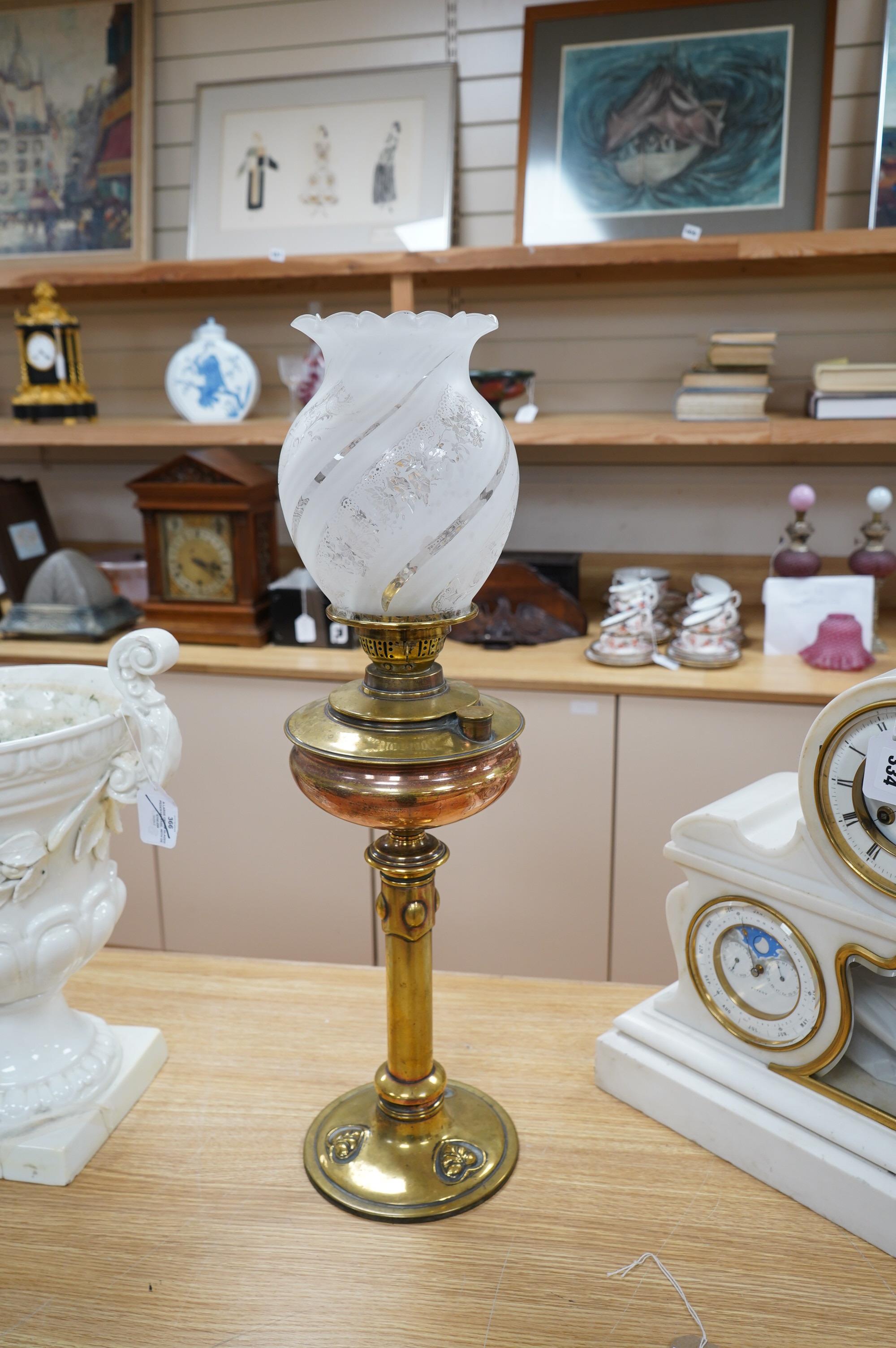 An English Arts and Crafts oil lamp with frosted acid etched shade, chimney, overall 74cm high. Condition – areas of old copper plating showing otherwise in good condition